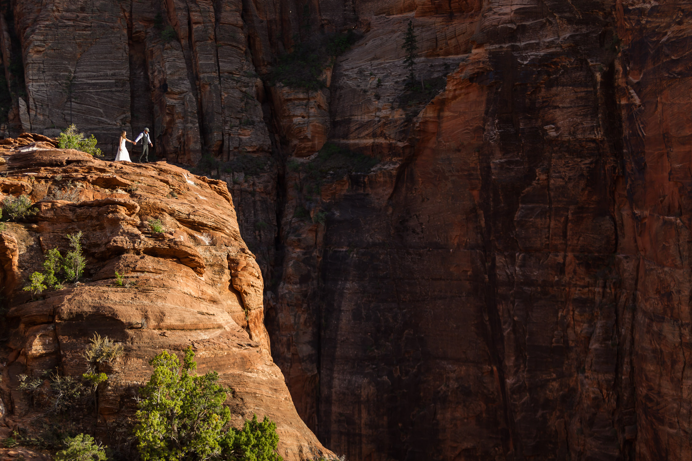zion national park wedding elopement couple portraits at canyon overlook hiking to the edge