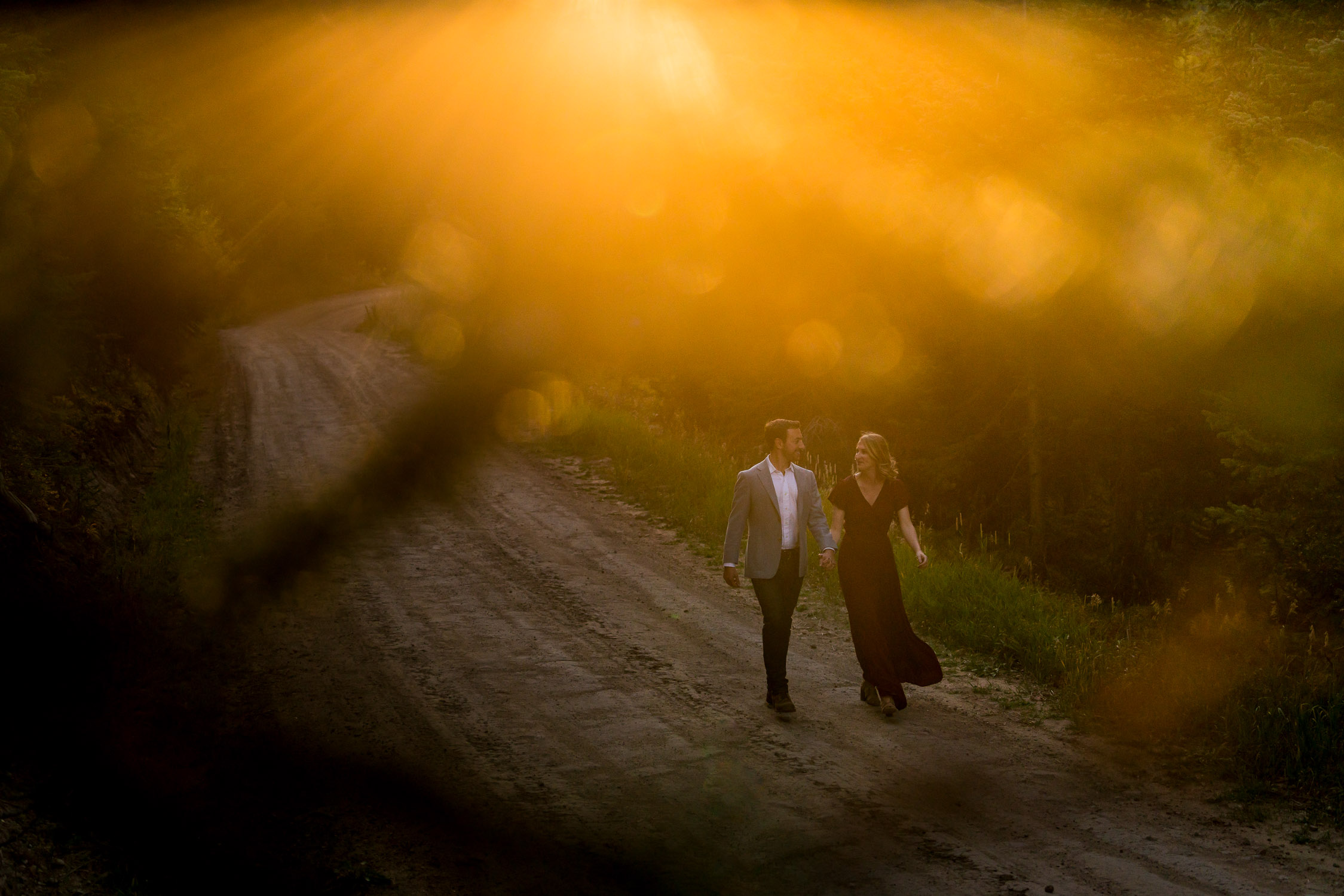 fall colors colorado engagement shoot with sunset light on a dirt road