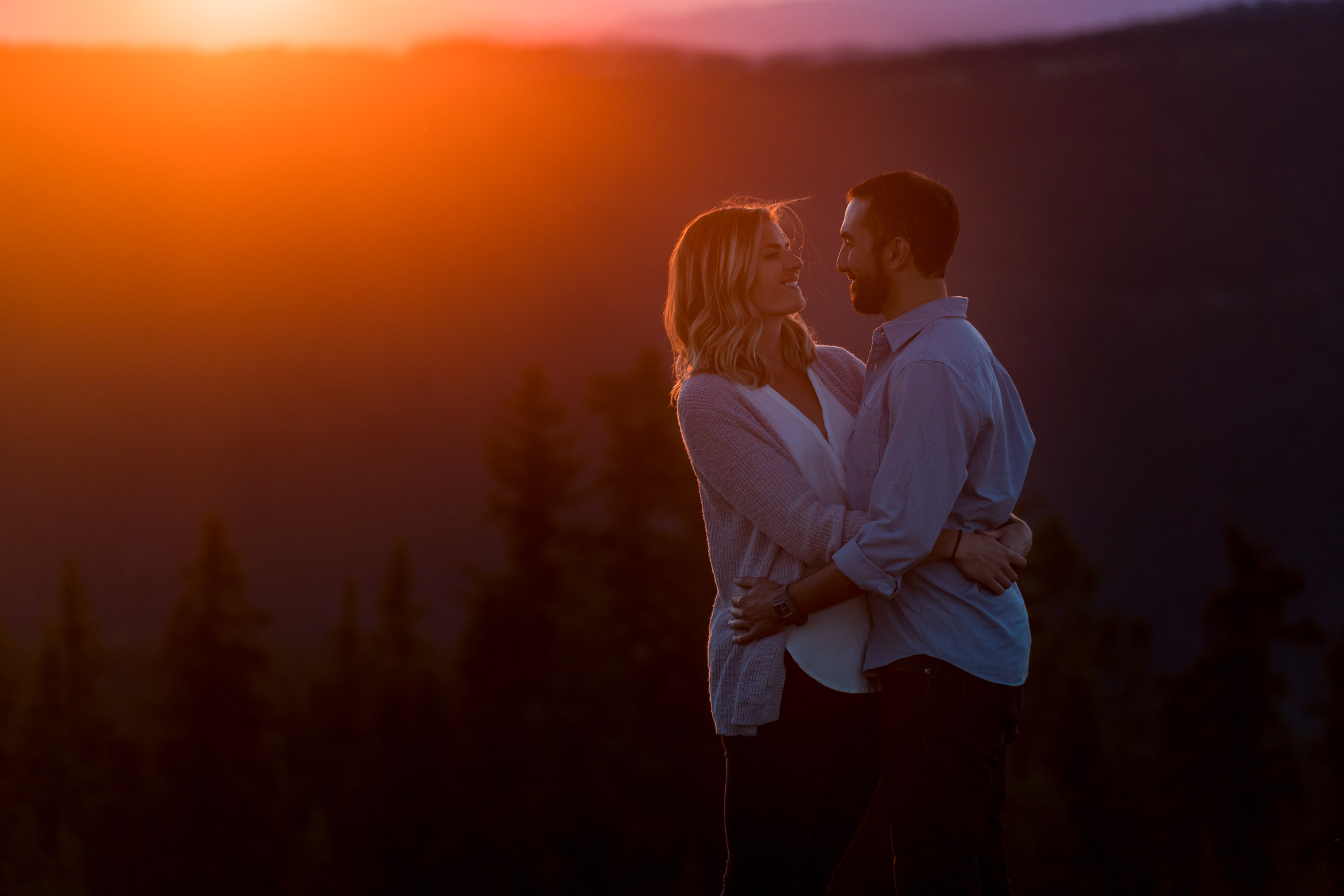 summer colorado mountain engagement with mountain views at sunset with golden light