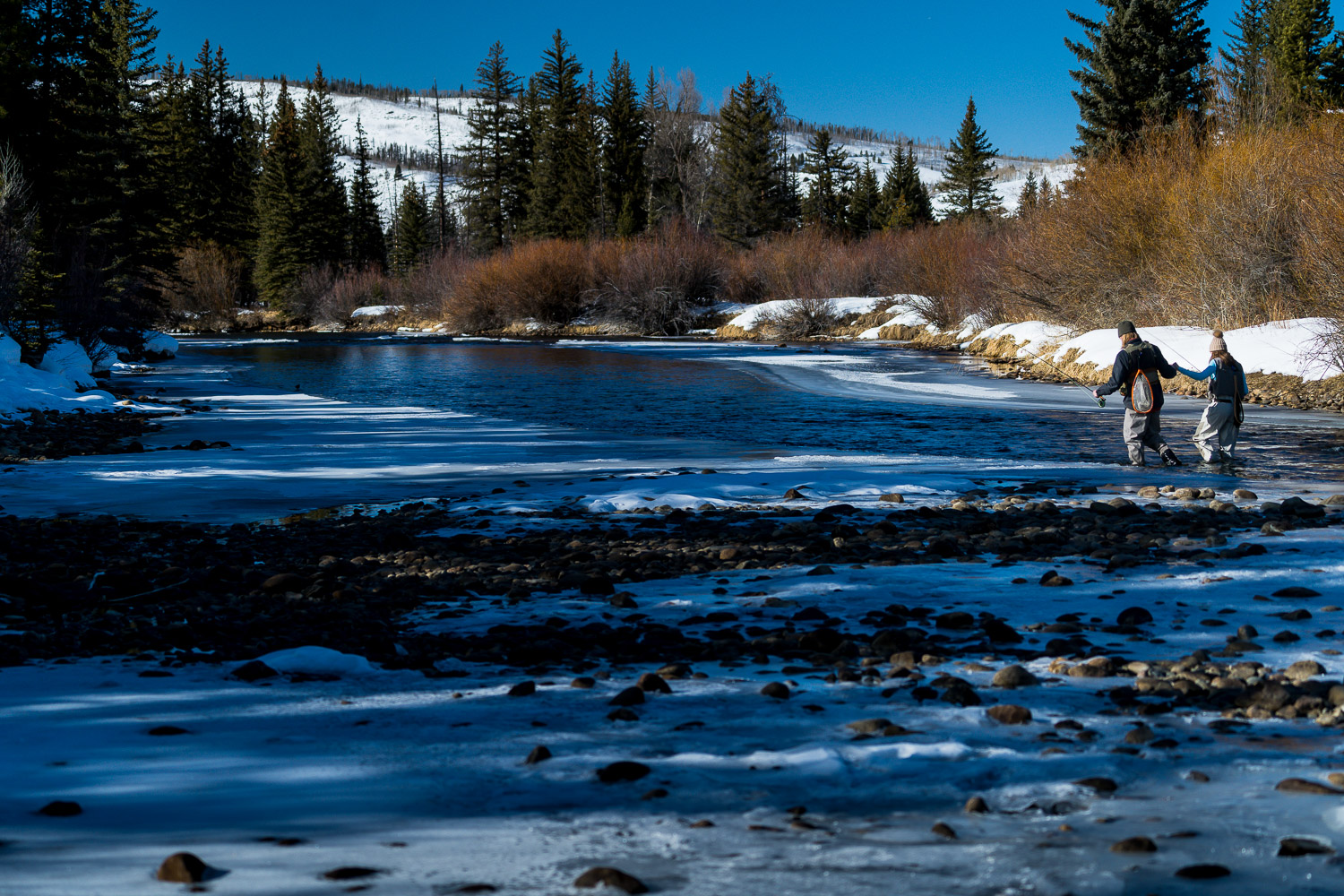 winter colorado engagement photos fly fishing