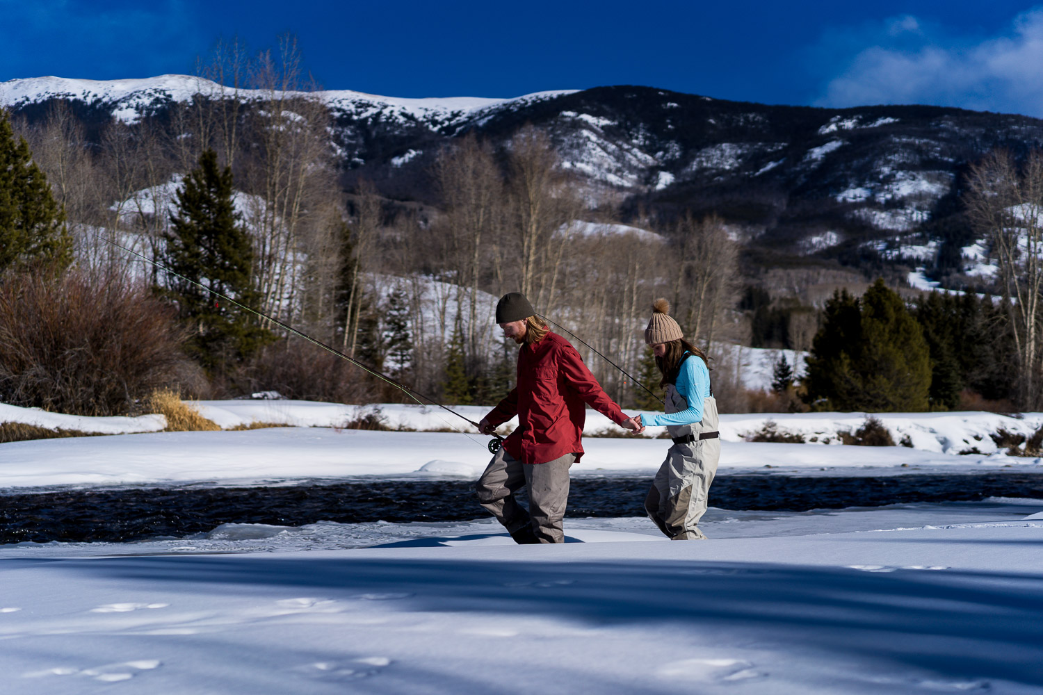 winter colorado engagement photos fly fishing on icy river