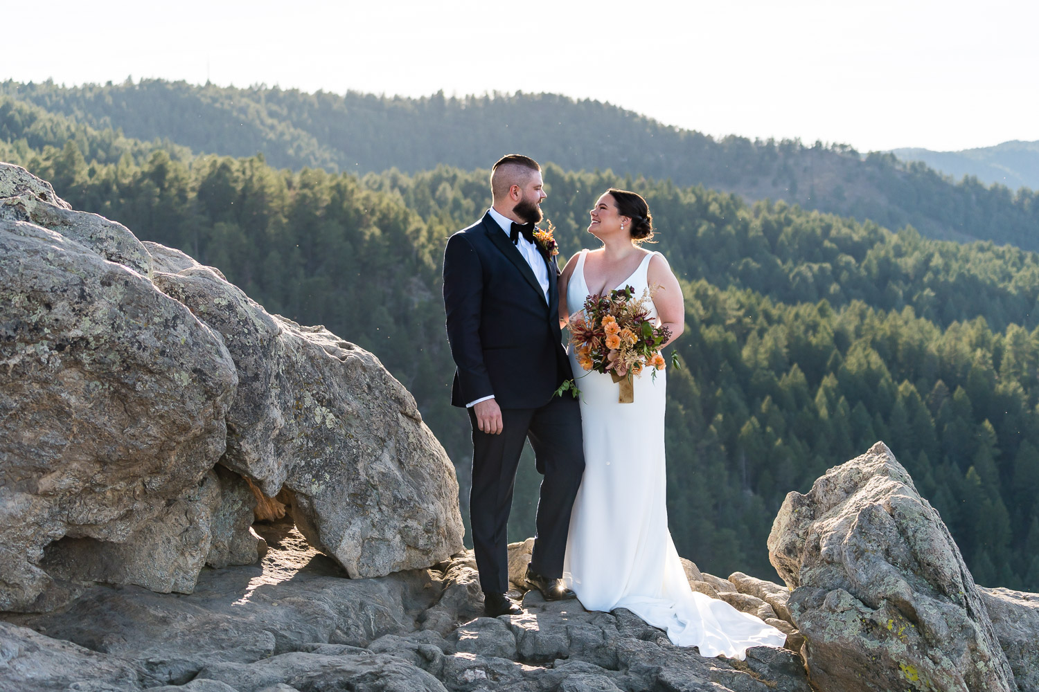 couple posing on rocks at flagstaff house wedding